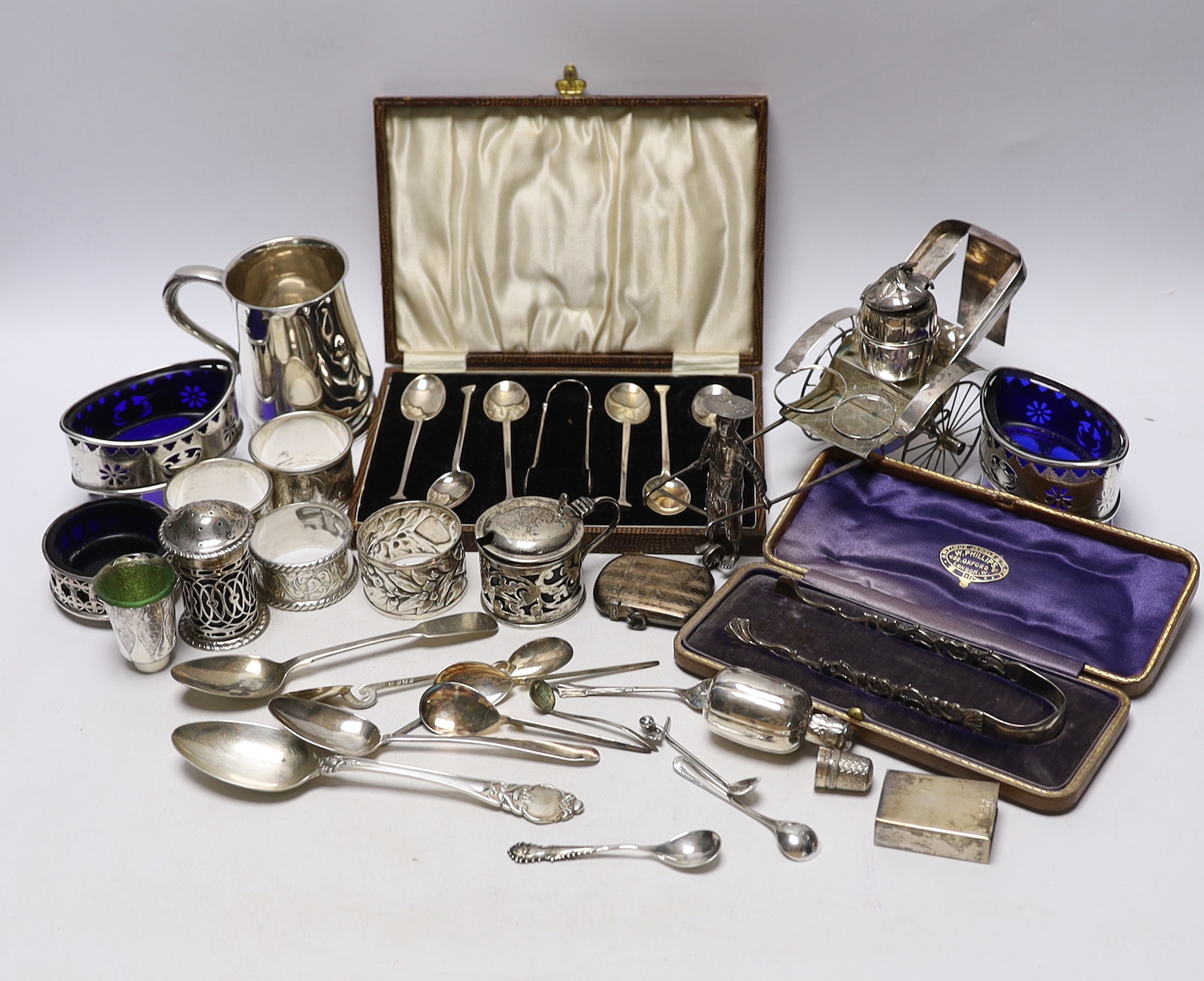 A collection of small silver to include a christening cup, a pair of late Victorian navette shaped salts, a Chinese white metal cruet (incomplete), flatware including cased teaspoons, vest case, napkin rings, etc.